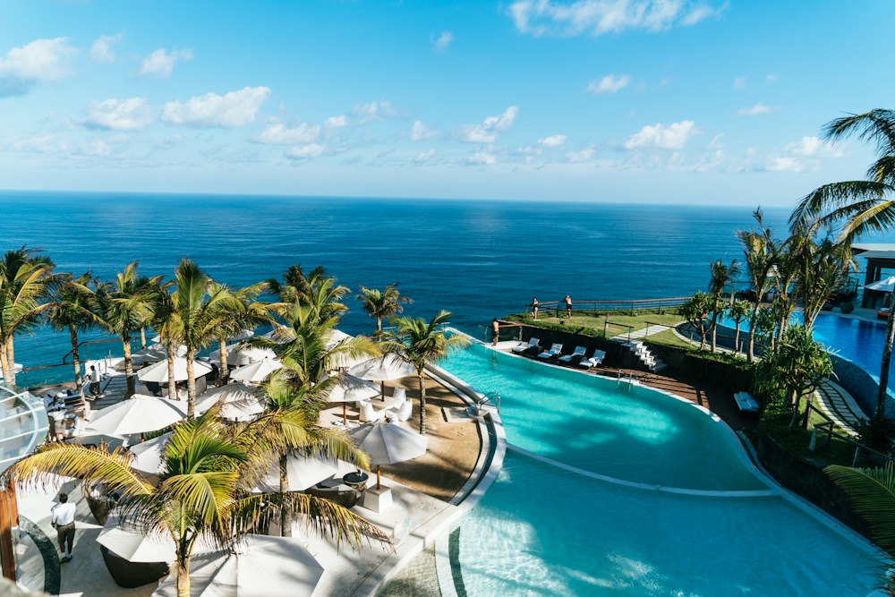 A resort pool overlooking a tropical coast